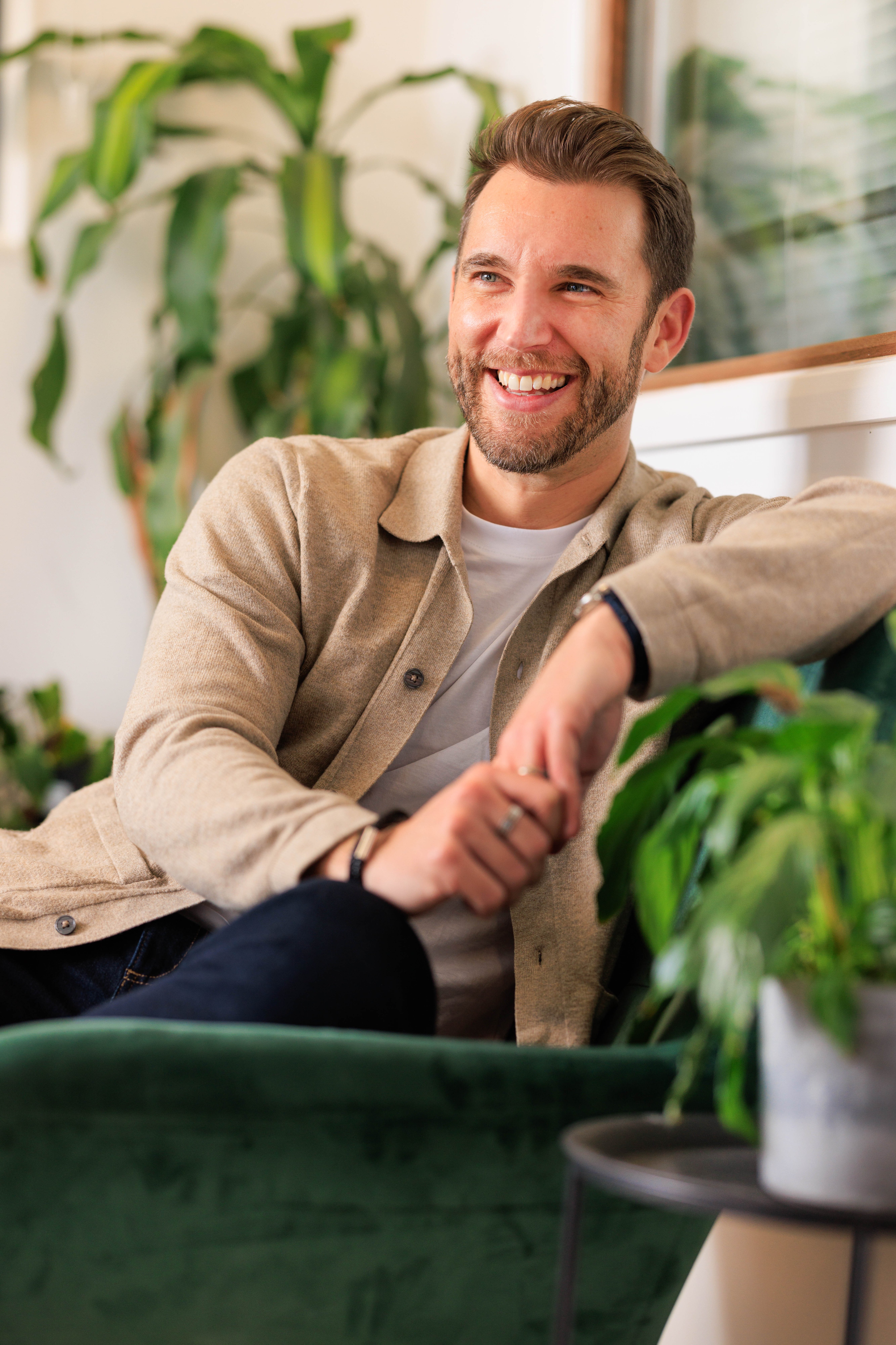 Jonathan Griffiths, keynote speaker on celebrating brilliant humans and workplaces, seated in studio